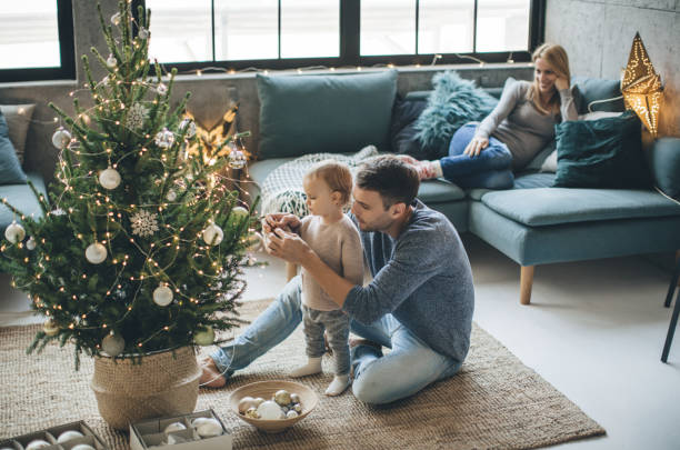 Father and daughter decorate a christmas tree | Carpet Advantage