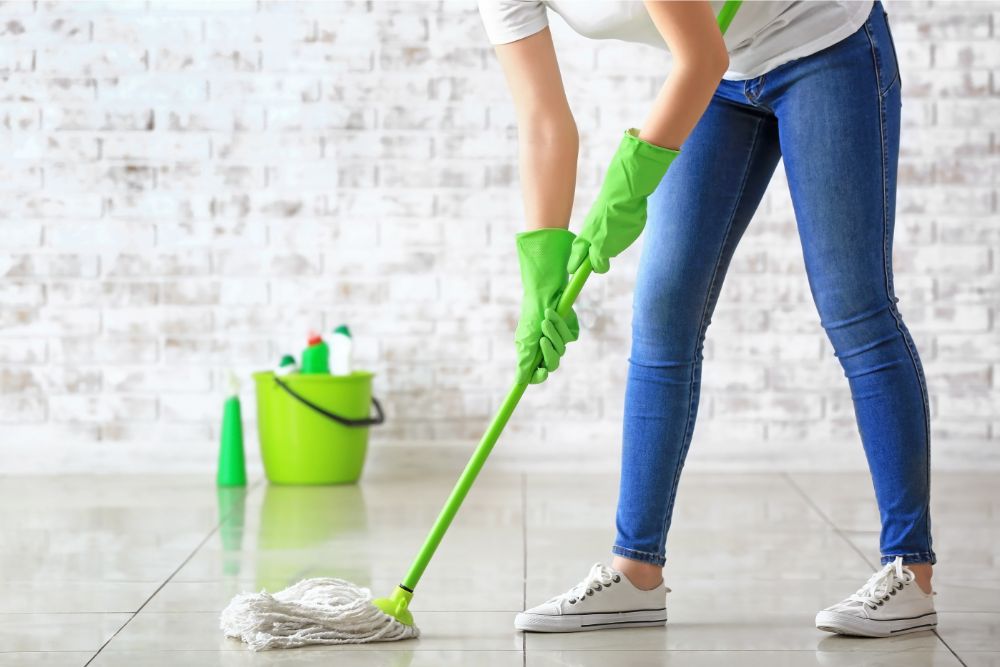 Woman cleaning tile floor | Carpet Advantage
